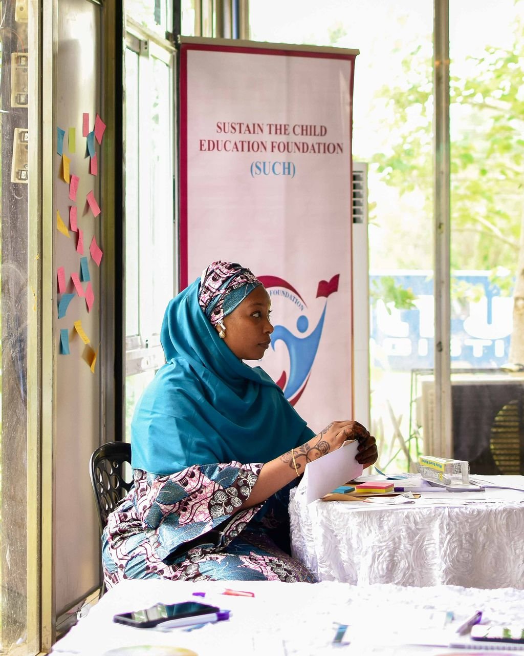 Mentor guiding a teenager over schoolwork